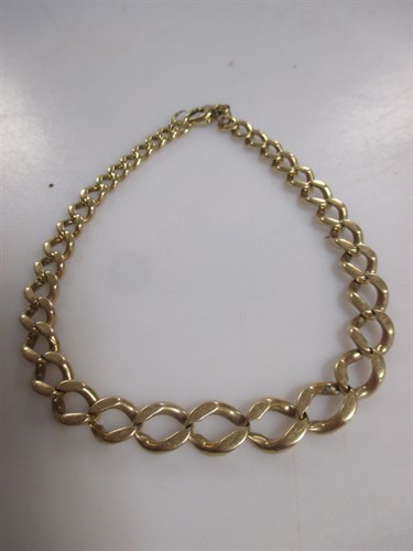 Lot 176 - A graduating curb link bracelet, unhallmarked...