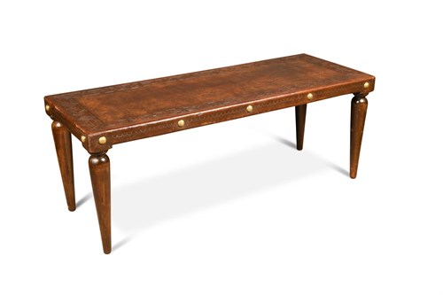 Lot 142 - A mid-20th century leather topped coffee table
