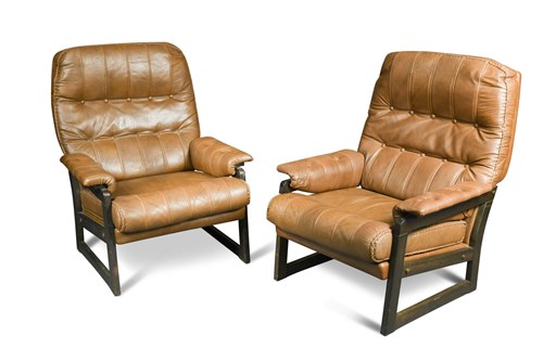 Lot 154 - A pair of tan brown buffalo hide upholstered lounge chairs