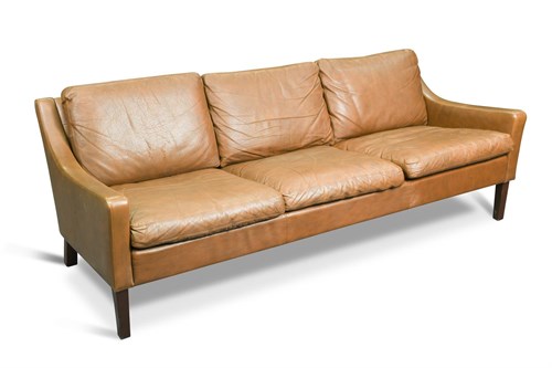 Lot 141 - In the manner of Børge Mogensen, a brown leather three-seat sofa