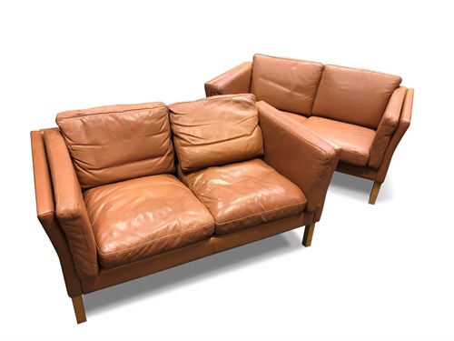 Lot 155 - A pair of Danish tan leather two-seat sofas