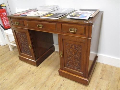 Lot 428 - A mahogany desk with green leather top and...