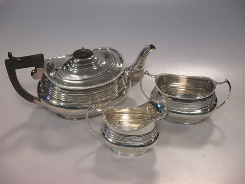 Lot 230 - A matched Chester silver three piece tea set,...