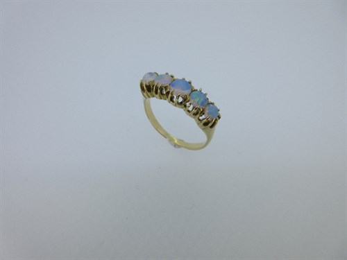 Lot 286 - A five stone opal half hoop style ring