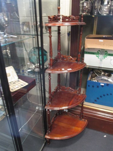 Lot 370 - A mid-Victorian four tier walnut corner whatnot