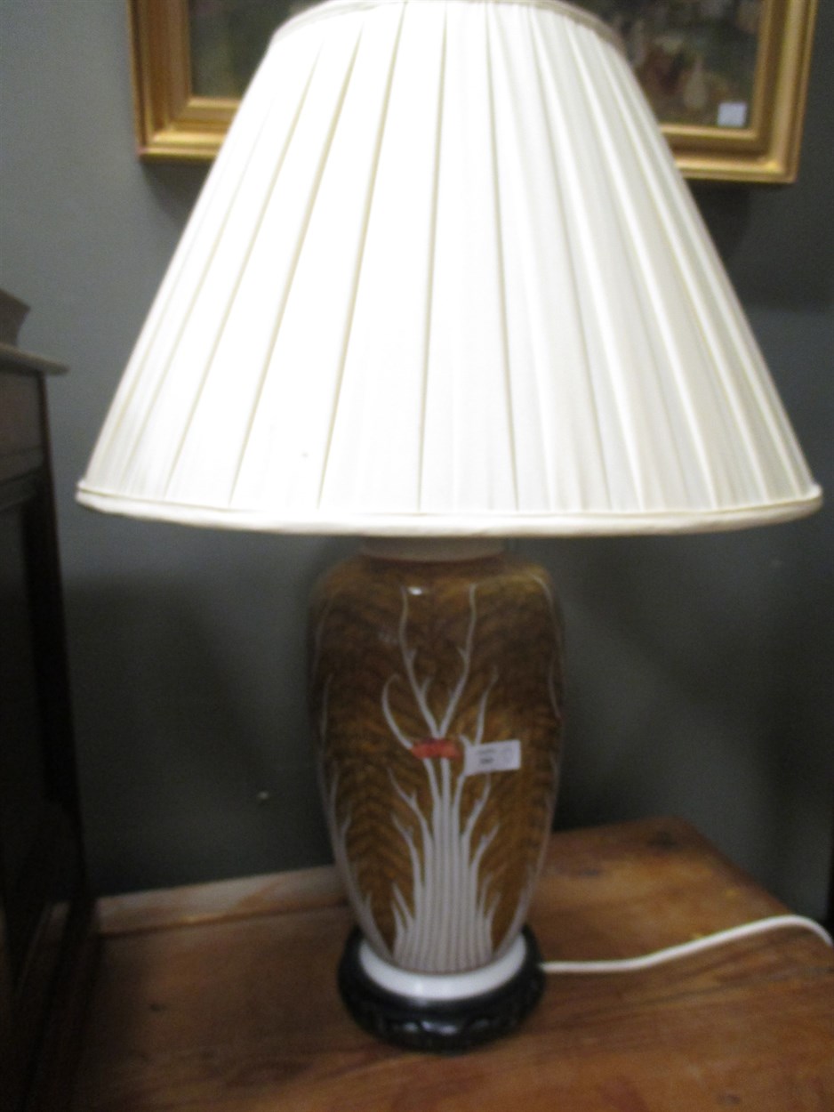 Lot 380 - A pair of Oriental table lamps on wooden...