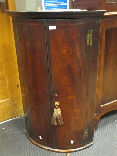 Lot 363 - A George III mahogany bowfront hanging corner...