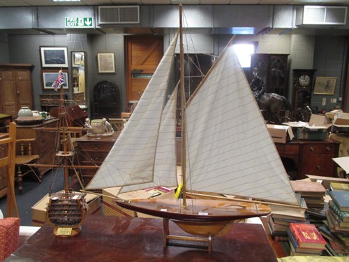 Lot 90 - A wooden model yacht on stand, and cross...
