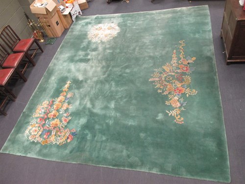 Lot 469 - A large Oriental green ground carpet, 418 x 362cm