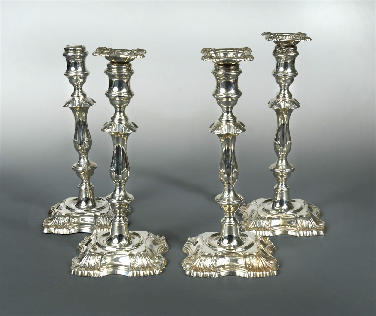 Lot 99 - A set of four Edward VII silver candlesticks