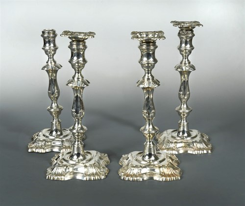 Lot 99 - A set of four Edward VII silver candlesticks