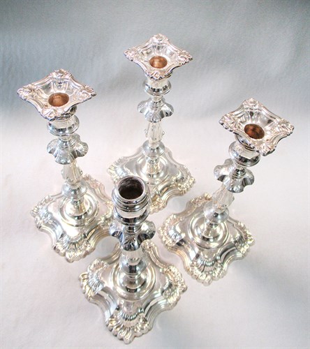 Lot 99 - A set of four Edward VII silver candlesticks
