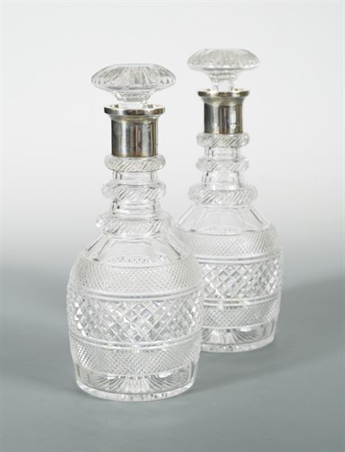 Lot 122 - A pair of George V cut glass decanters with silver collars