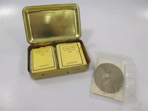 Lot 112 - A WWI tin containing cigarettes and chocolate...