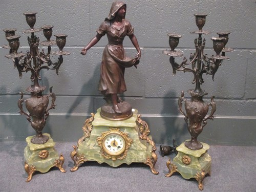 Lot 129 - A 19th century spelter clock with garniture on...