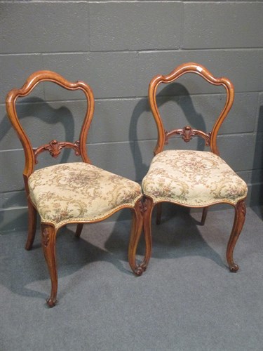 Lot 340 - A set of four walnut dining chairs