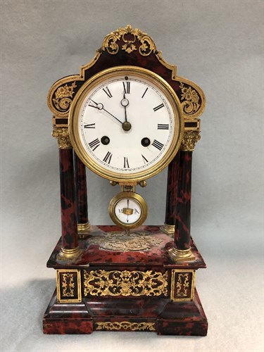 Lot 290 - A 19th century French tortoiseshell and gilt metal mounted portico type mantle clock