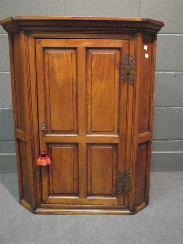 Lot 447 - A George III yew wood corner cupboard with...
