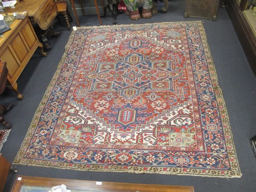 Lot 385 - A Heriz pattern large red ground rug 284 x 214cm