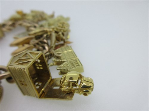Lot 222 - A 9ct gold charm bracelet with a large quantity of charms