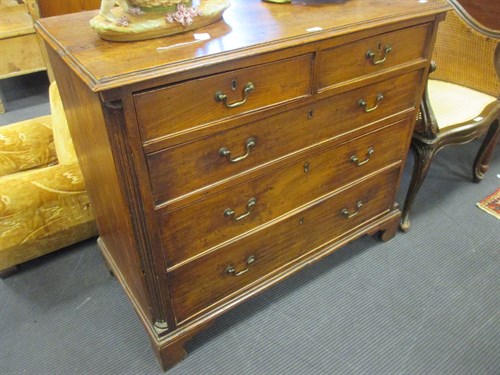 Lot 335 - A George III elm chest of drawers with...