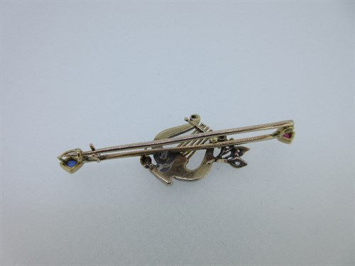 Lot 311 - An antique diamond and gem set lyre brooch