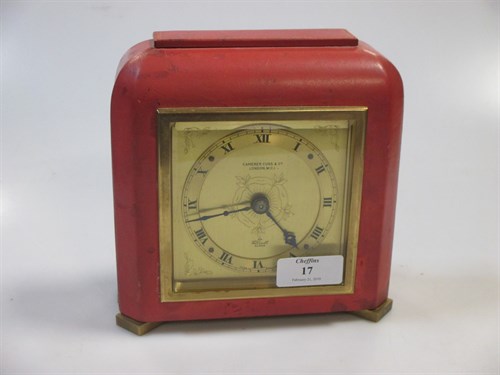 Lot 17 - A coral coloured leather covered mantel clock...