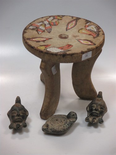 Lot 102 - A three footed African stool with bead...