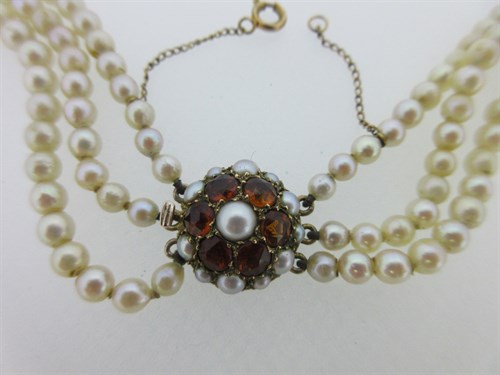 Lot 249 - A three row cultured pearl necklace with citrine clasp