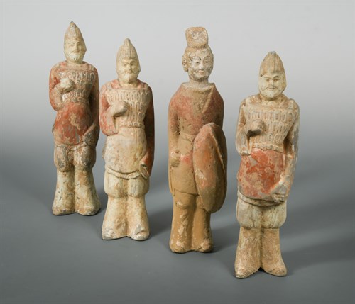 Lot 18 - A group of four pottery models of soldiers, Northern Wei period