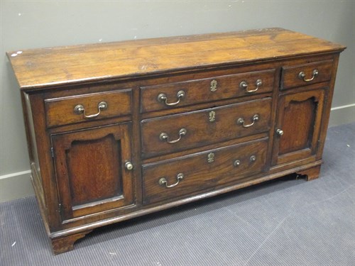 Lot 499 - An 18th century oak dresser base, with drawers...