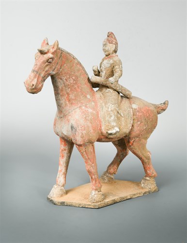 Lot 26 - A painted pottery figure of a horse and rider, possibly Tang dynasty