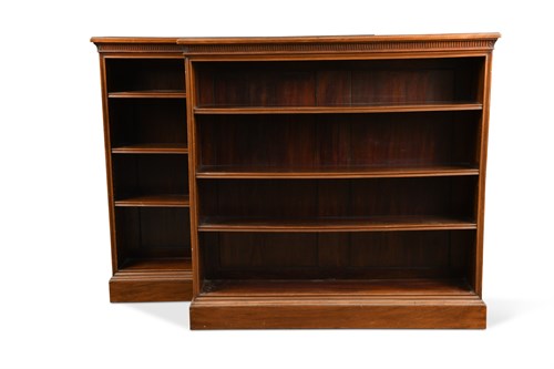Lot 672 - A pair of late Victorian walnut open front bookcases