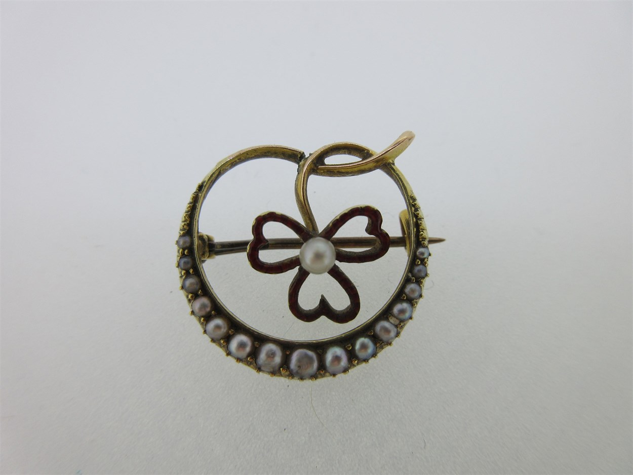 Lot 248 - A seed pearl and enamel crescent and shamrock brooch
