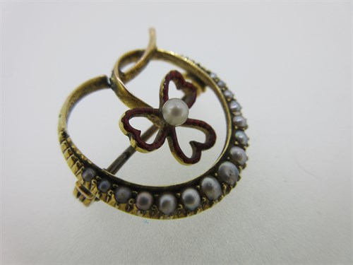 Lot 248 - A seed pearl and enamel crescent and shamrock brooch