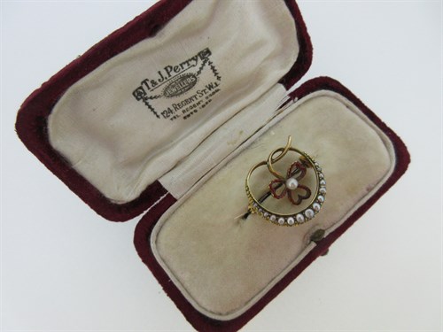 Lot 248 - A seed pearl and enamel crescent and shamrock brooch