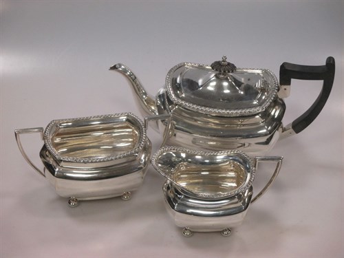 Lot 288 - A silver three piece tea set by Walker and...