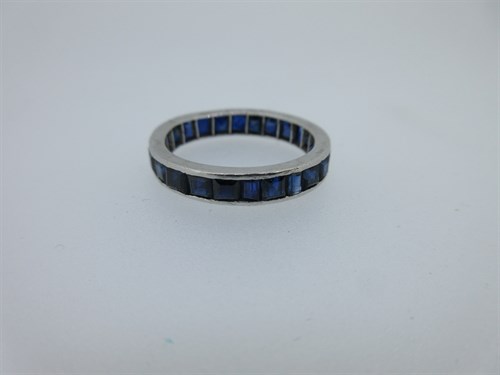 Lot 412 - A sapphire full hoop eternity ring