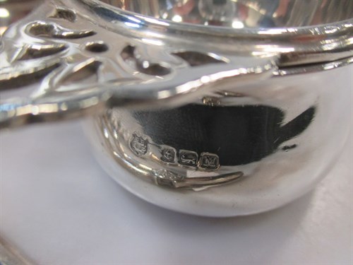 Lot 249 - A silver tea strainer, a pair of silver grape...