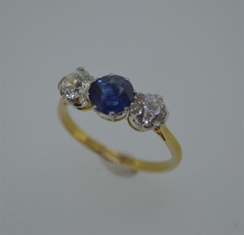 Lot 373 - A diamond and sapphire three stone ring