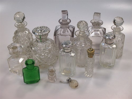 Lot 180 - A collection of cut glass scent bottles, three...