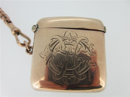 Lot 265 - A 9ct rose gold double Albert watch chain with attached gold swivel fob and vesta case