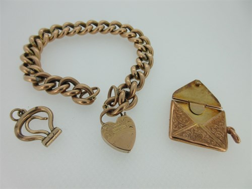 Lot 269 - A 9ct gold bracelet with heart locket, hallmarked stamp case and button hook pendants