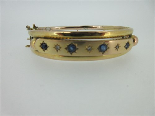 Lot 434 - Two period sapphire set pieces - a hinged bangle and a bead-edged brooch
