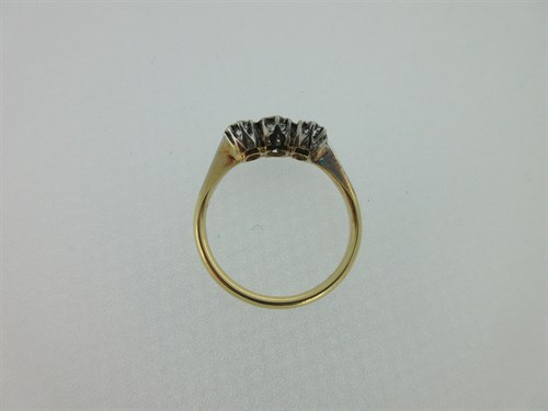 Lot 379 - A diamond three stone ring and a ruby and diamond five stone ring