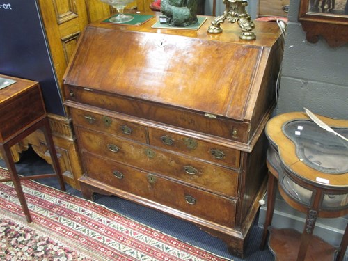 Lot 443 - A George I walnut bureau, with two short and...