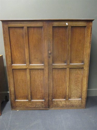 Lot 383 - A walnut panelled two door cupboard with...