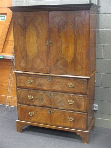 Lot 412 - A 19th century walnut linen press