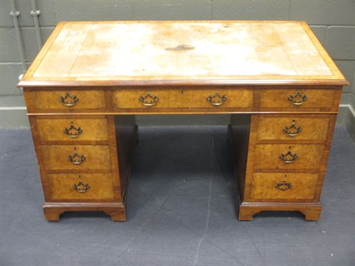 Lot 374 - A leather inset walnut pedestal desk 77 x 135...