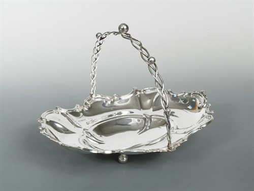 Lot 396 - An Edward VII silver swing handled basket